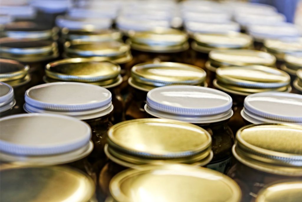 Photo showing the tops of canning jars that are slightly concave