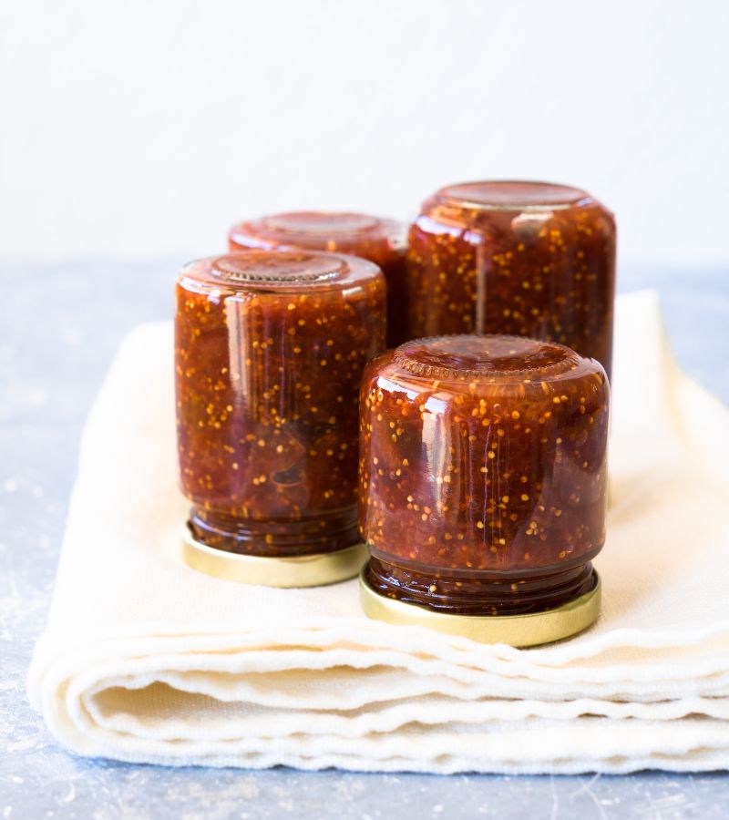 Small jars of fig jam turned upside down