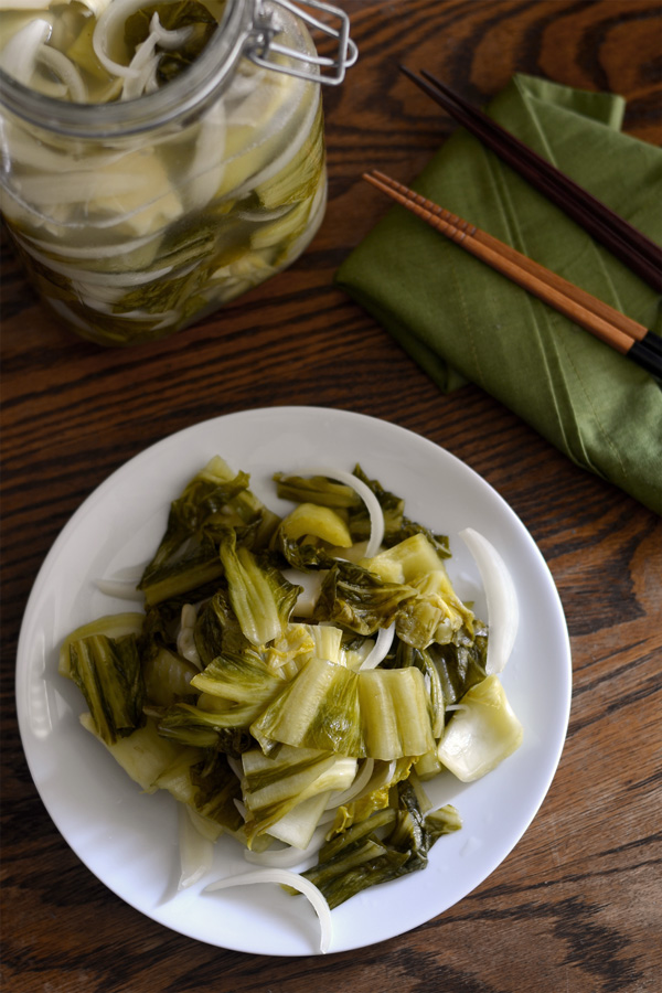 Pickled mustard greens and onions on a plate