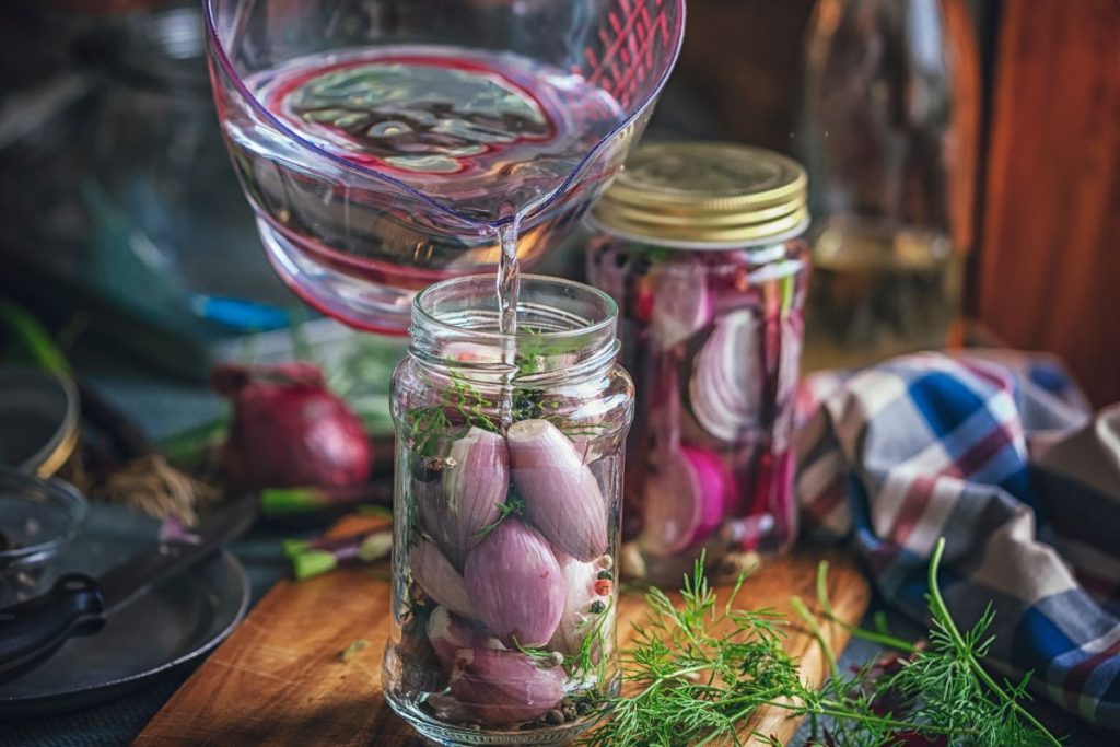 Filling canning jars with water and leaving an inch of headspace