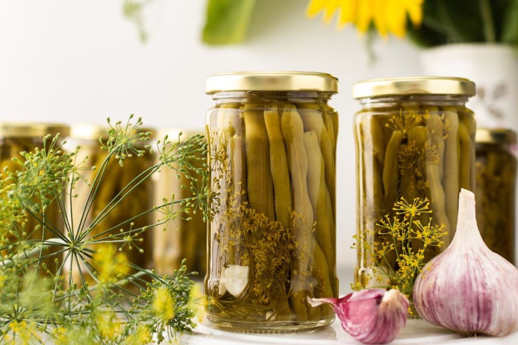 Canned asparagus jars with garlic and dandelions