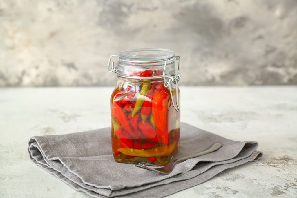 jar of pickled red and green peppers