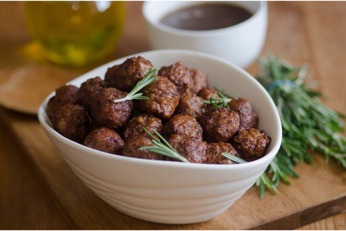 meatballs with fresh herbs in a white bowl