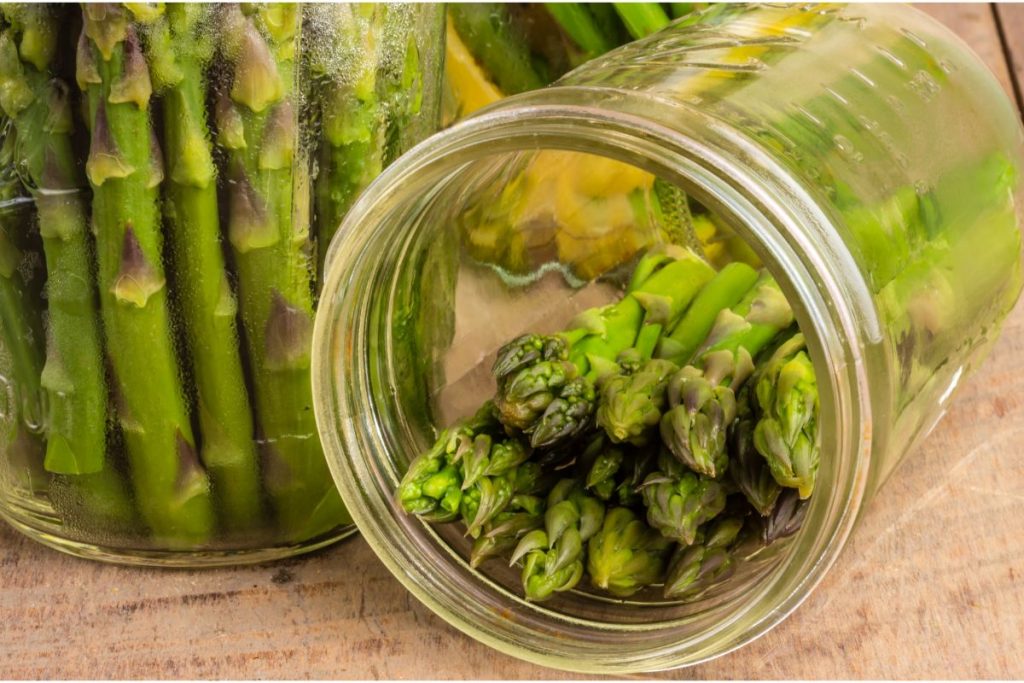 Packing firm asparagus spears into canning jars