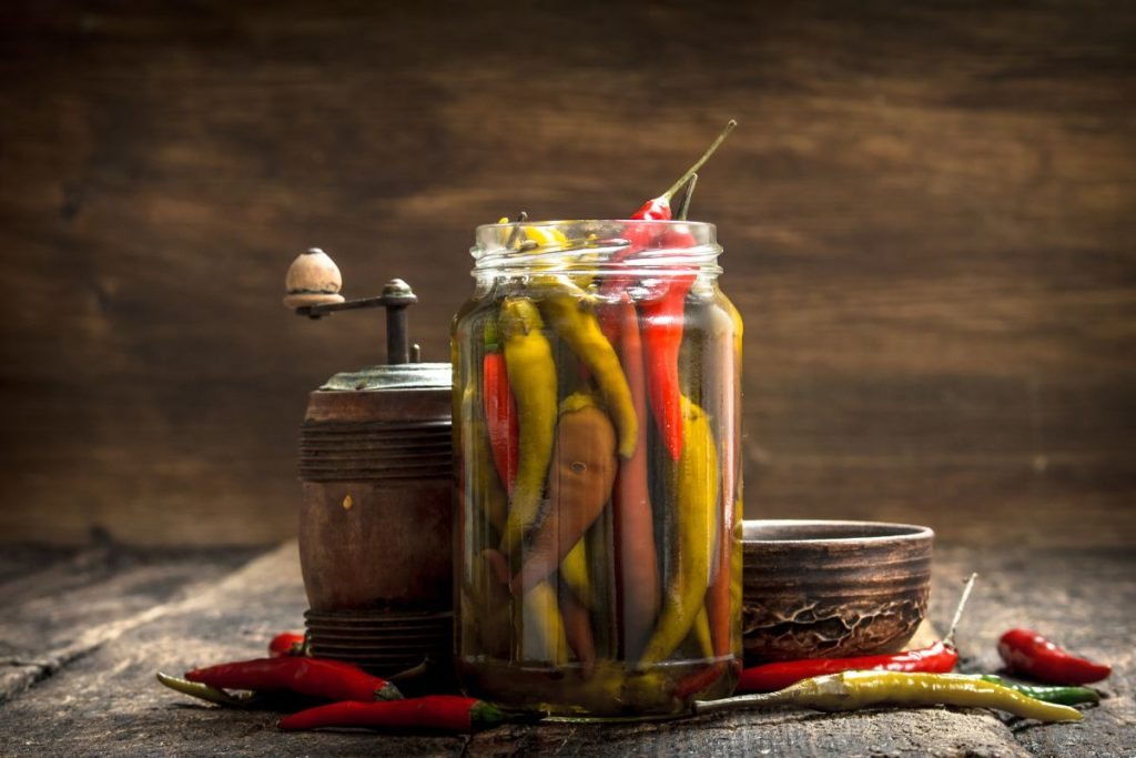 Glass jar of pickled chili peppers