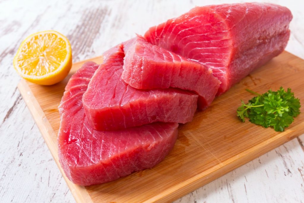 Raw tuna filets on cutting board