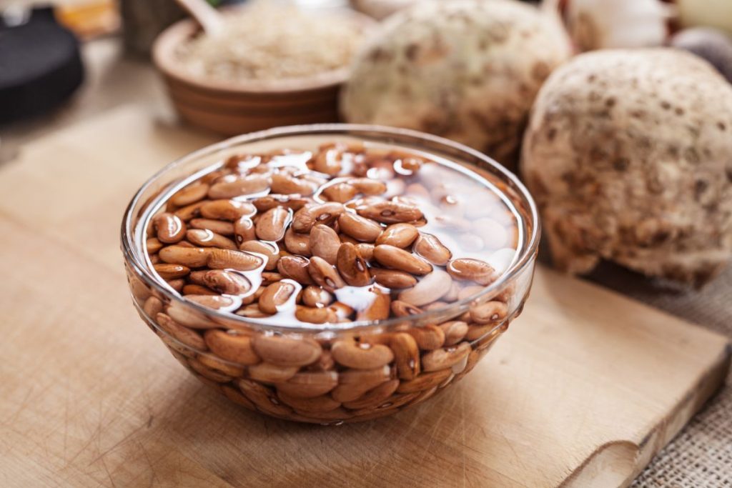 Soaking dried pinto beans in a bowl with water