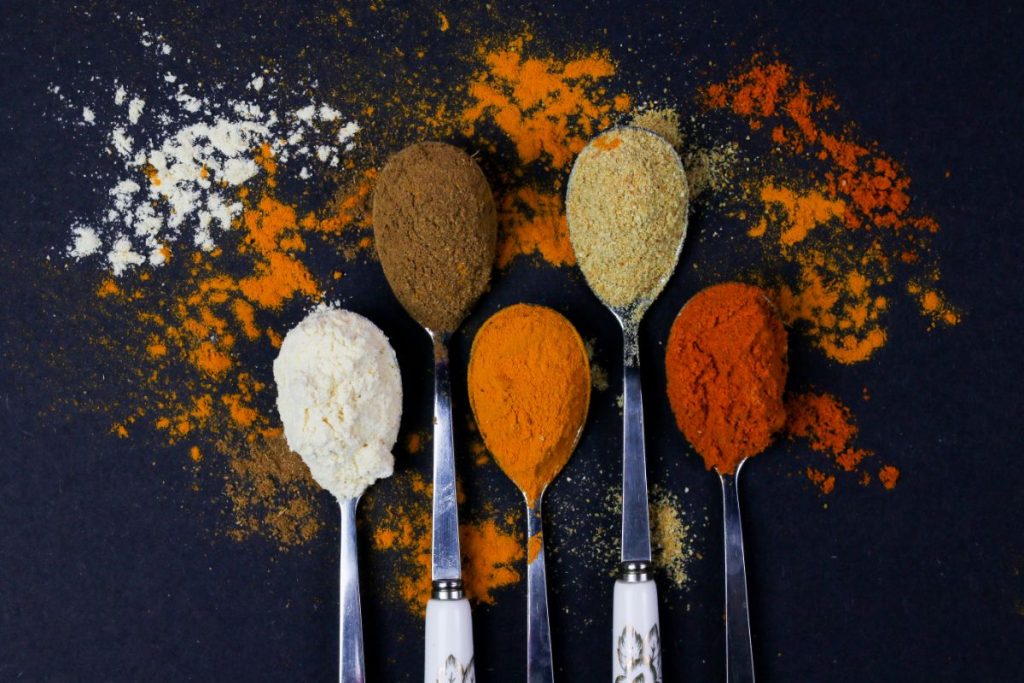 Spoons filled with different spices