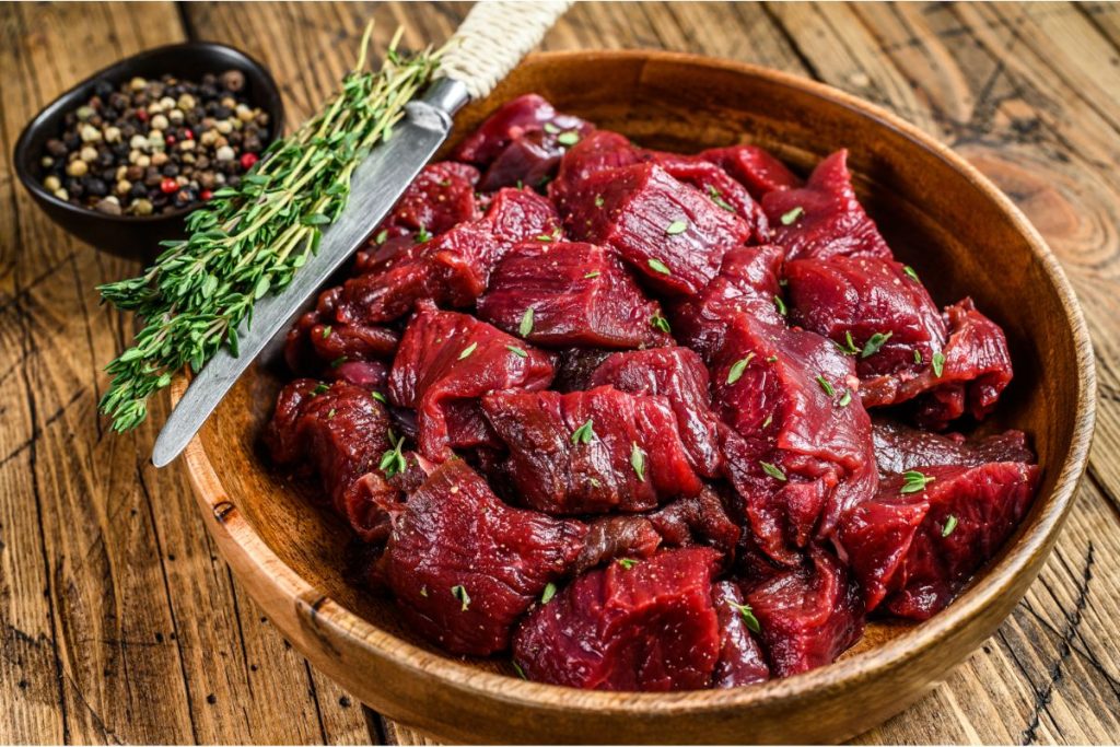 Bowl of cubes of raw venison meat
