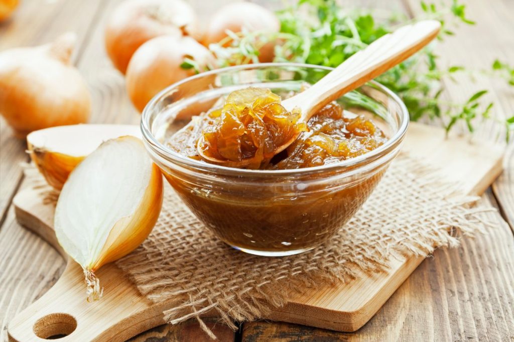 Bowl with wooden spoon of caramelized onion jam