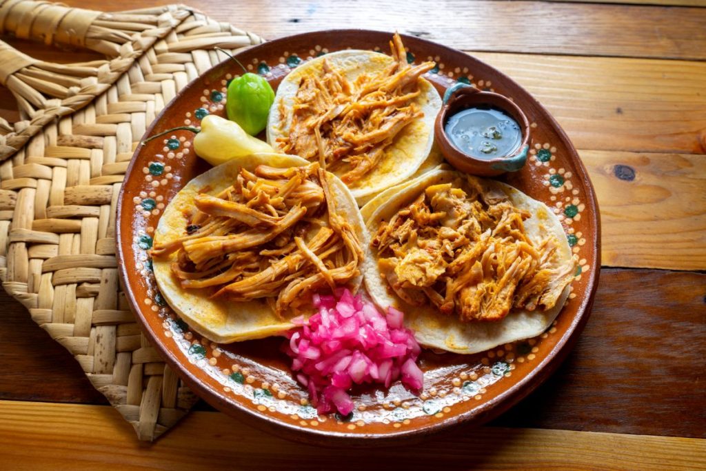 Tacos with red pickled onions on a plate