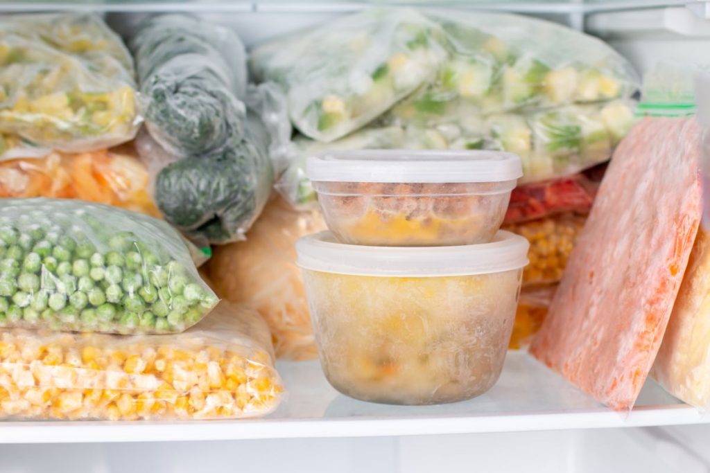 Frozen gumbo and vegetables in a freezer in airtight containers