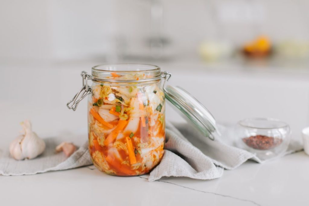 Open jar of Kimchi in a Mason jar