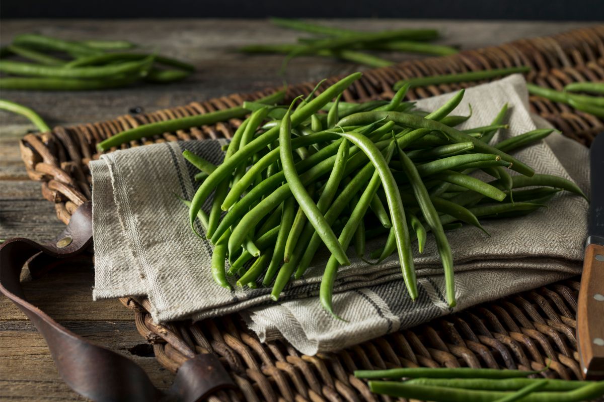 Raw green beans on placemat
