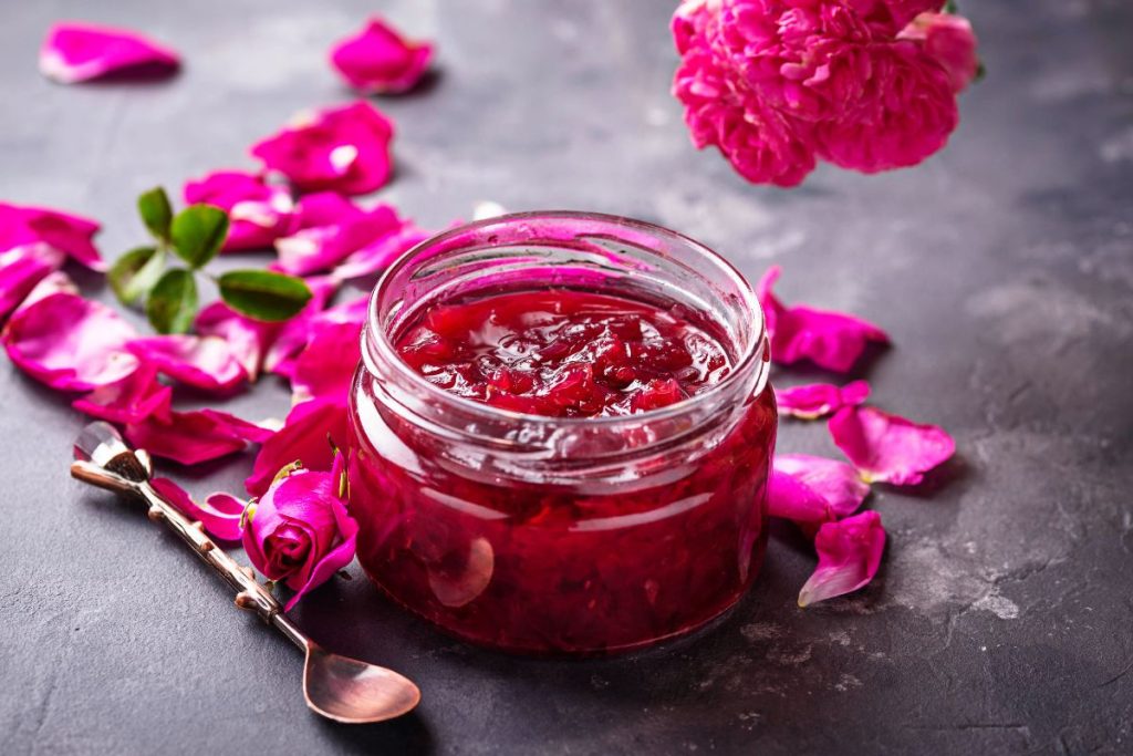 Rose jelly in a jar with rose petals