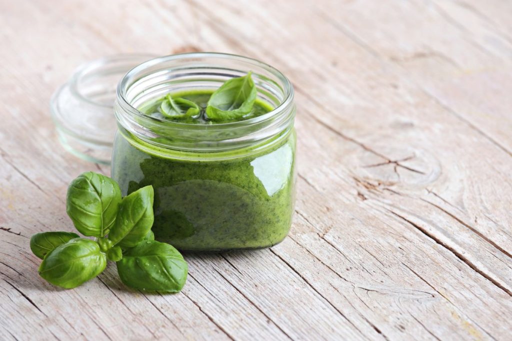 Open jar of basil pesto