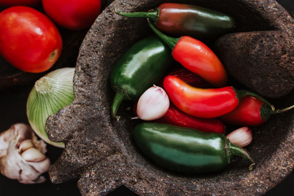 Enchilada sauce ingredients in a stone pestle