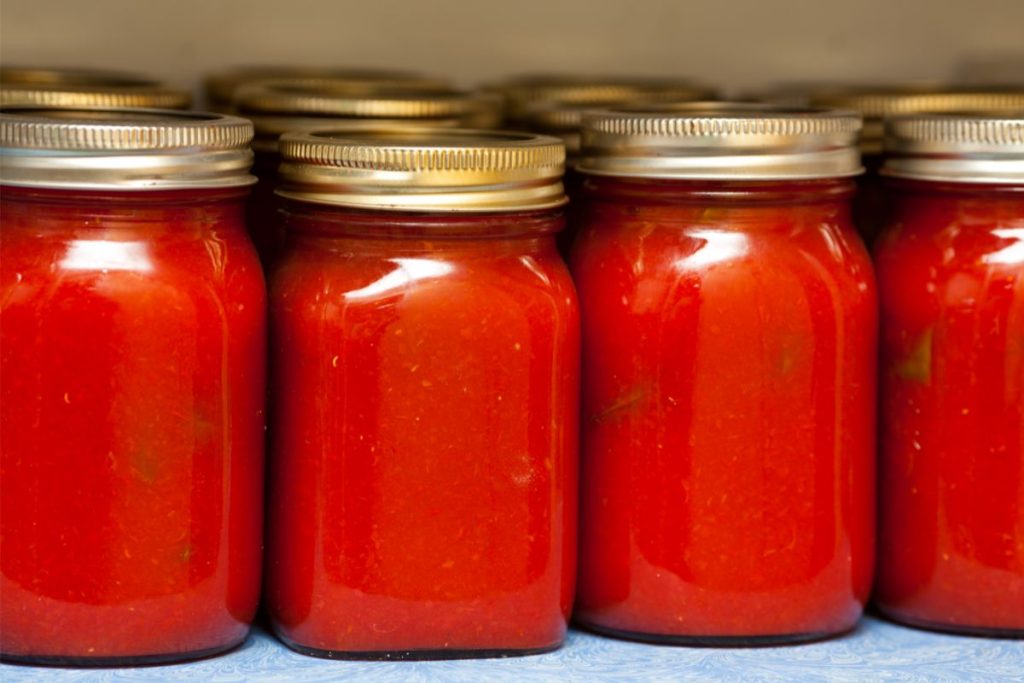 Canned pizza sauce stored on a shelf