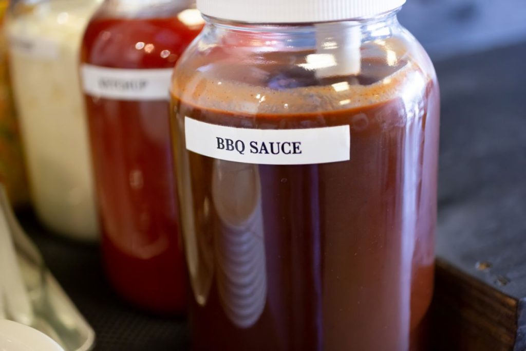 Large jar of labeled homemade bbq sauce