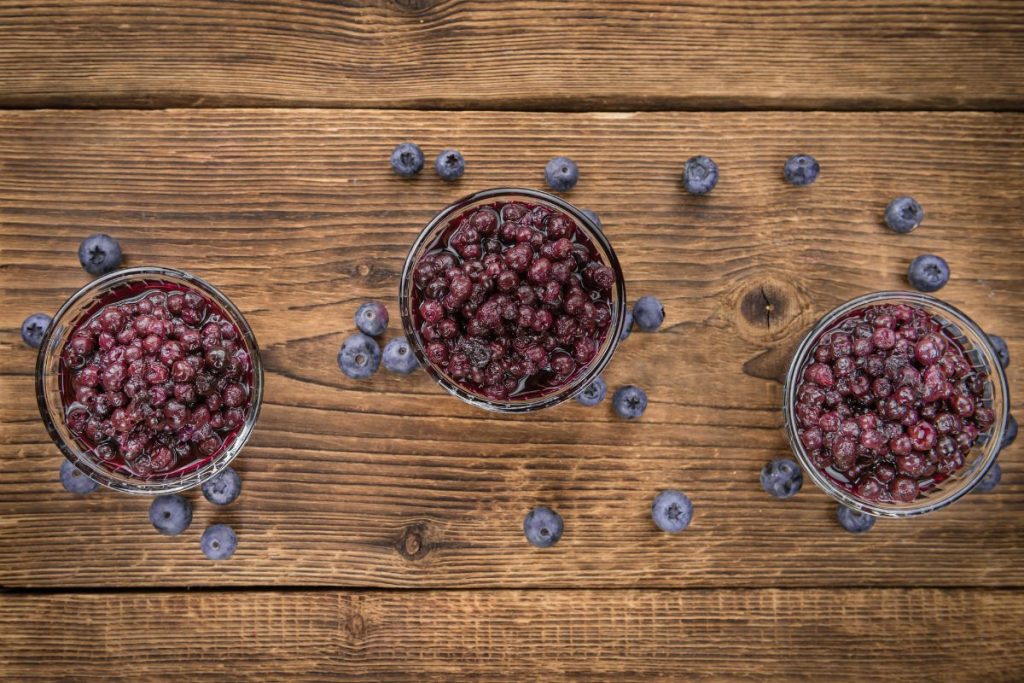 Three canning jars full of hot packed blueberries