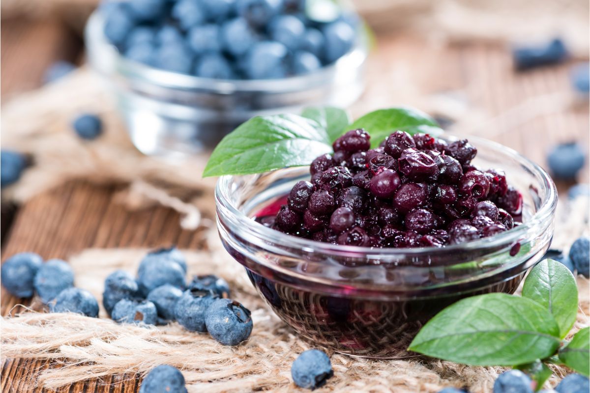 Glass bowls of fresh and canned blueberries