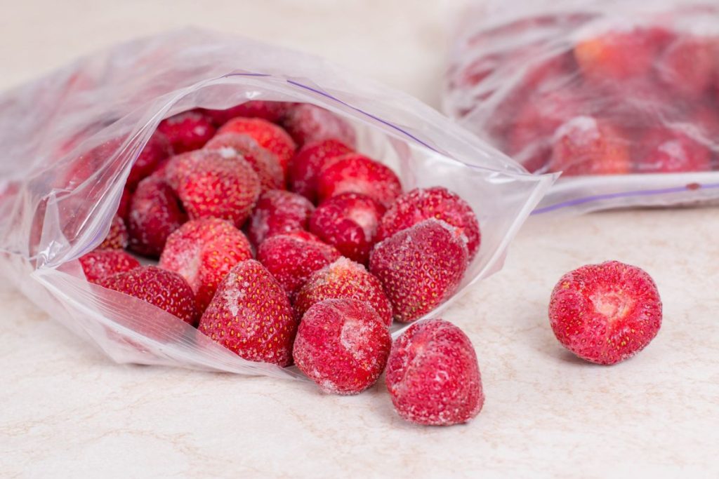 Frozen strawberries in open freezer bag