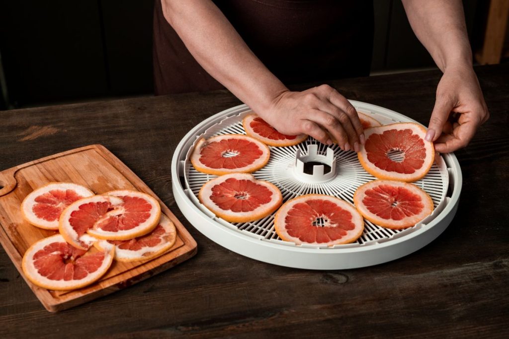 Dehydrating grapefruit on a food dehydrator tray