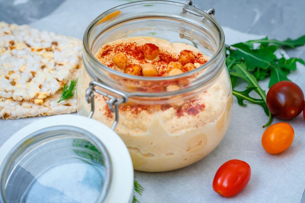 Hummus in a jar topped by canned chickpeas