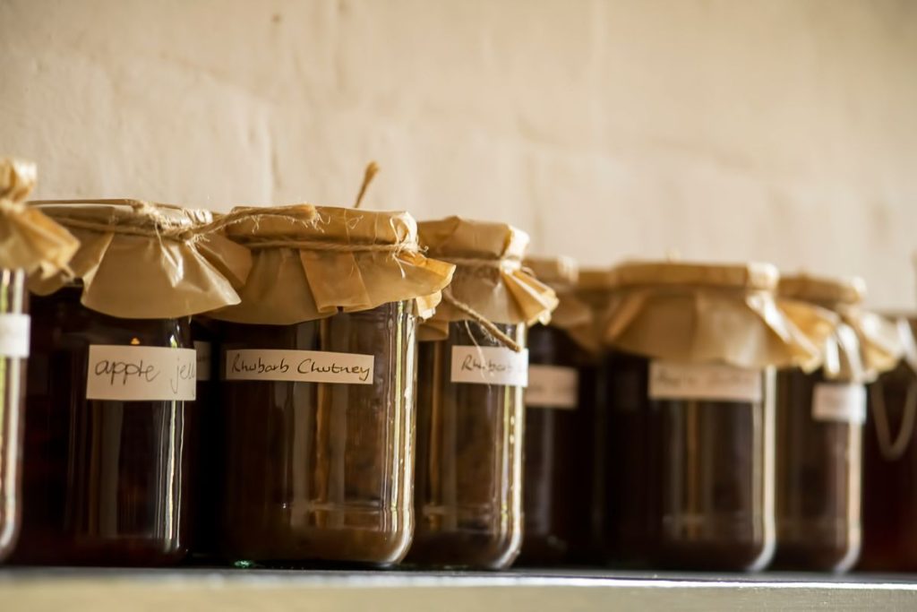 Jars of canned goods with stick on, handwritten labels