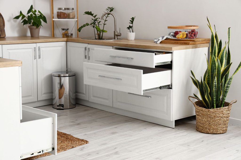 Opened drawers in a white kitchen
