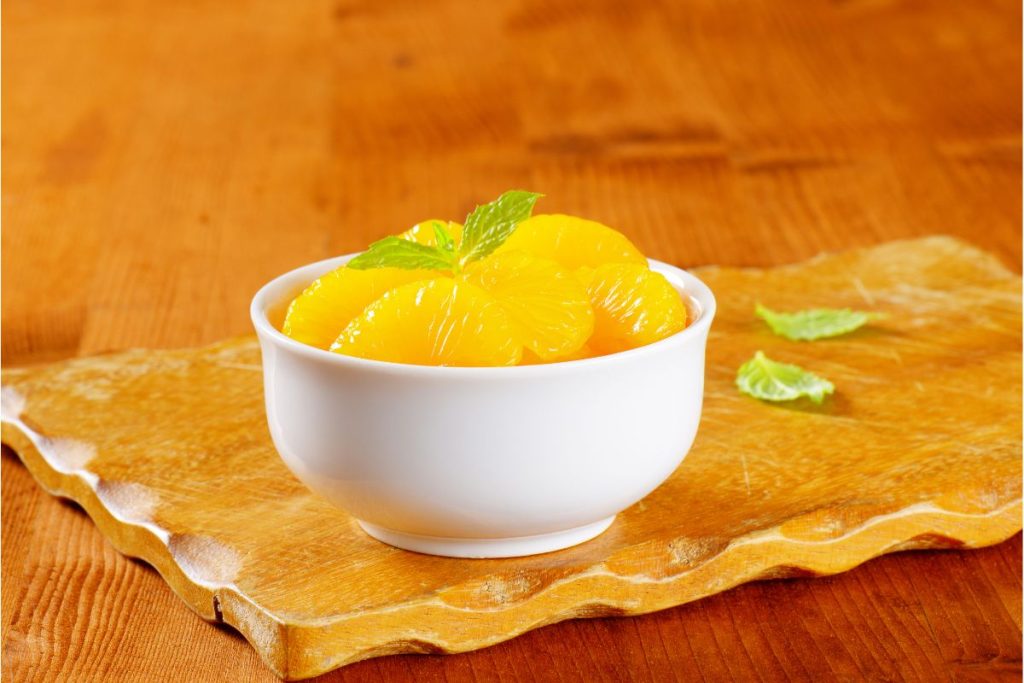 White bowl filled with canned mandarin orange slices