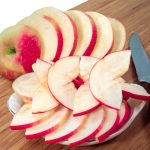 Sliced red apples on a cutting board