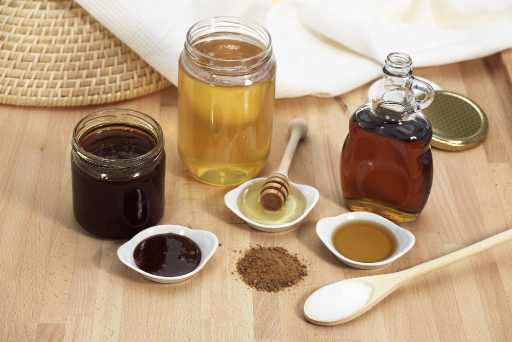 Types of sweeteners including honey, agave, maple syrup, and table sugar